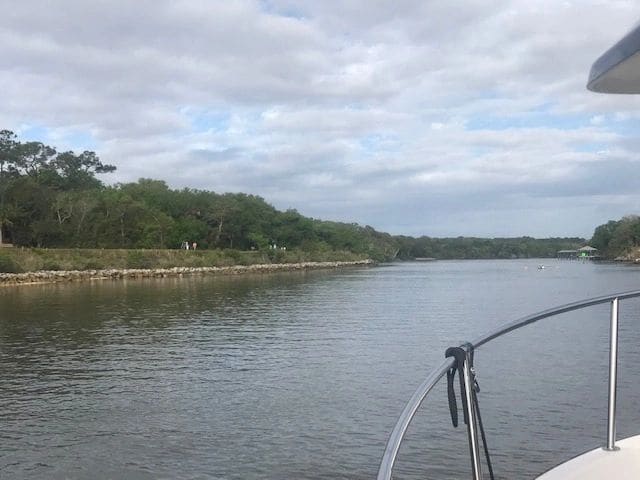 Passing Palm Coast. Much activity—walkers/runners, bikers, sculls in the water.